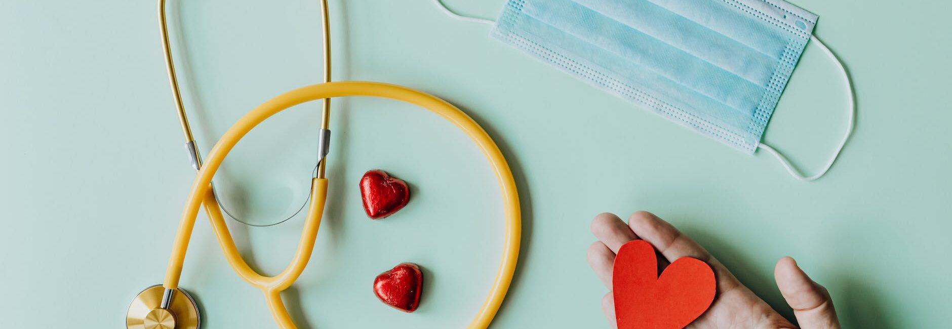 medical stethoscope and mask composed with red foiled chocolate hearts