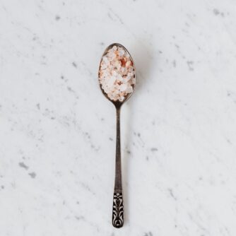spoon with salt and spices on table