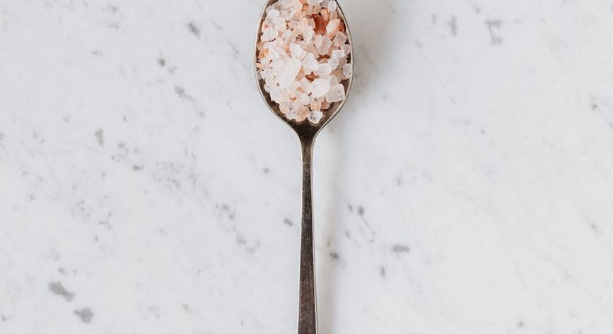spoon with salt and spices on table