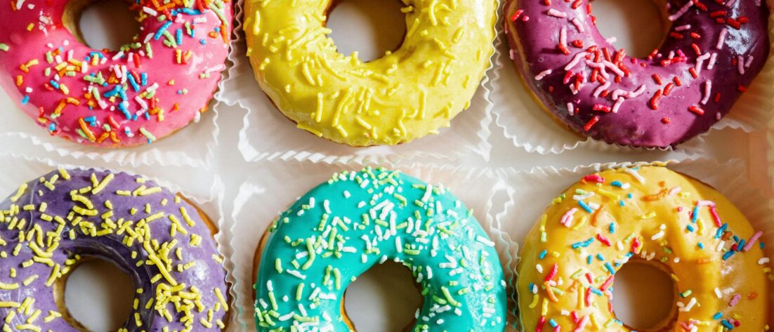 pink doughnut on white textile