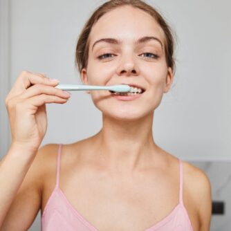 a woman brushing her teeth
