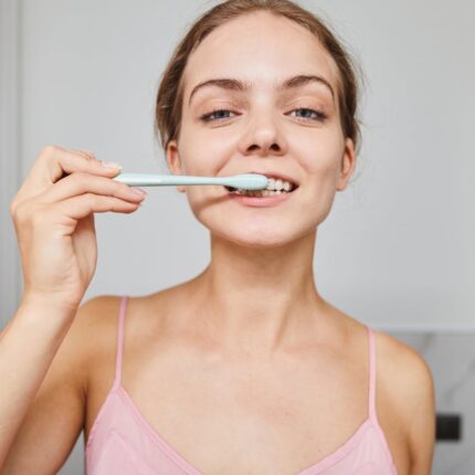 a woman brushing her teeth