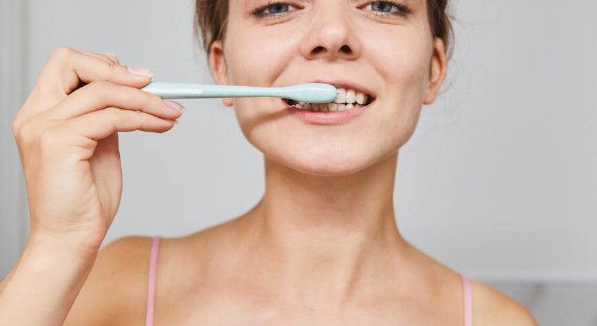 a woman brushing her teeth